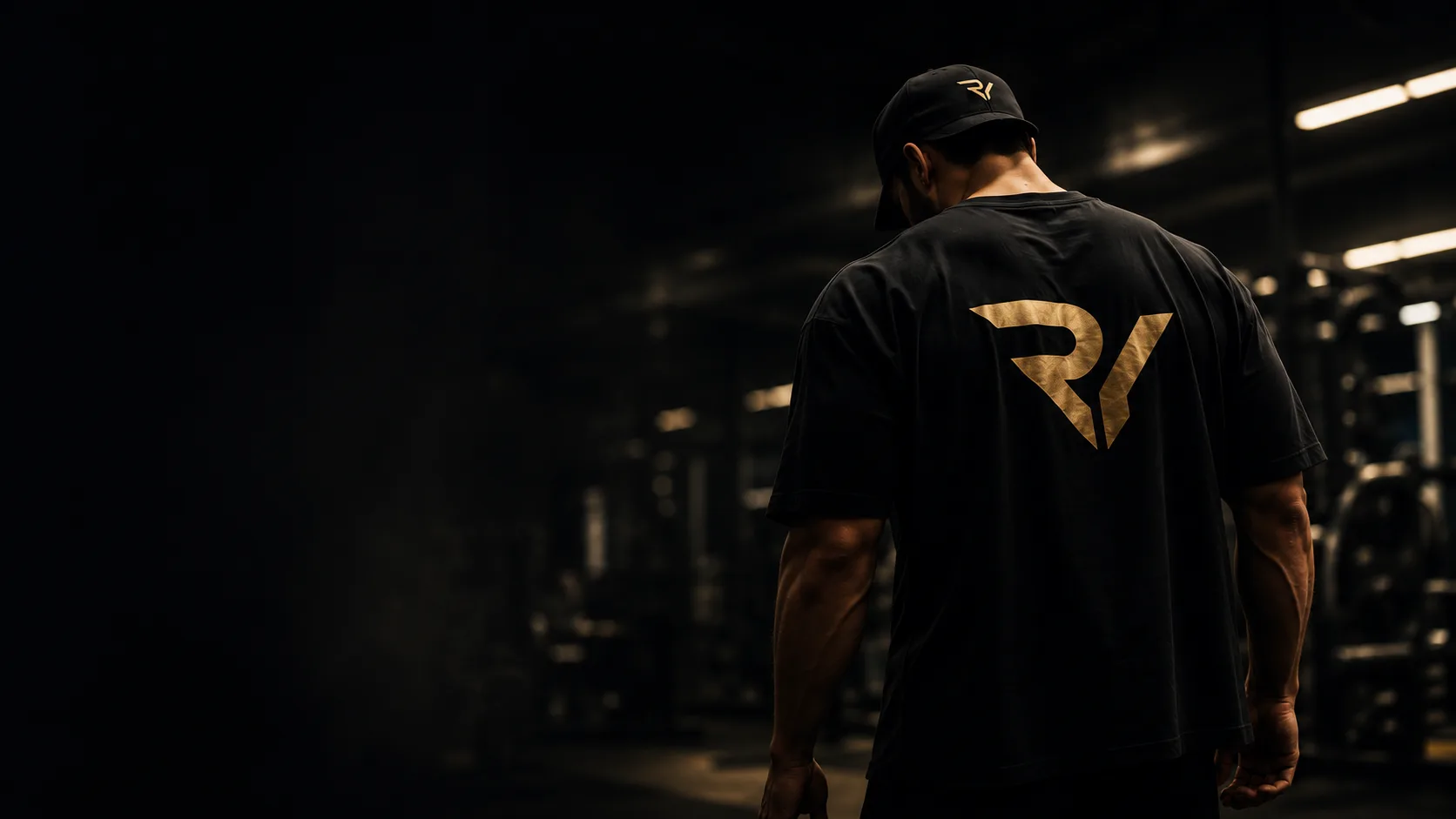 Athlete in a Resurrect You tee walking through a dark gym